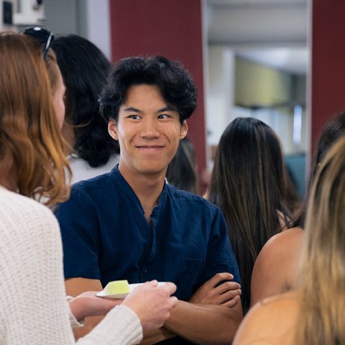 Students chat in a hall