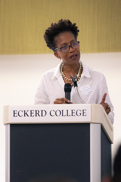 Woman speaking at podium that says Eckerd College