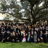 Group of graduates on a quad in caps and gowns