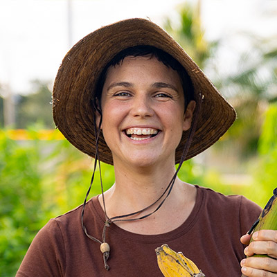 Farmer wearing hat, holding bananas