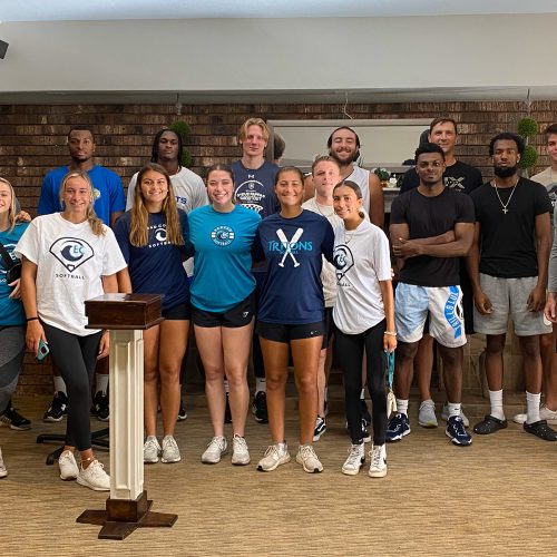 Group of softball and basketball students stand side by side