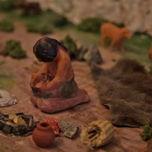 Model figurines of Native American people in a nature scene