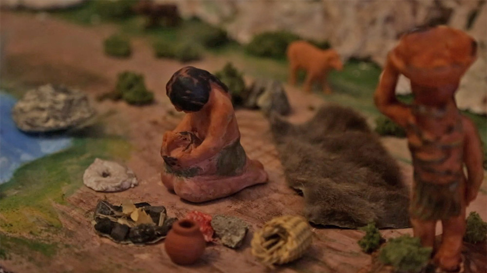 Model figurines of Native American people in a nature scene