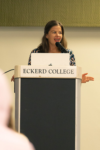 Speaker stands at a podium with the words "Eckerd College"