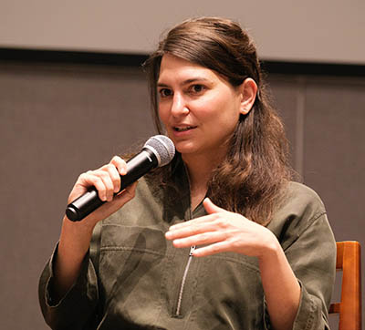 Woman speaking into microphone while speaking