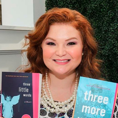 Woman holding up two books