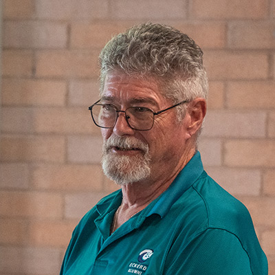 Man in glasses and shirt that reads "Eckerd Alumni"