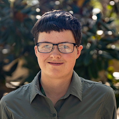 Student wearing glasses and smiling at camera