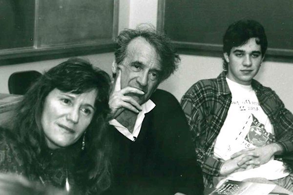 Johnston and Wiesel sit with a student at desks