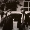 Students walk across campus with Wiesel in suit and tie