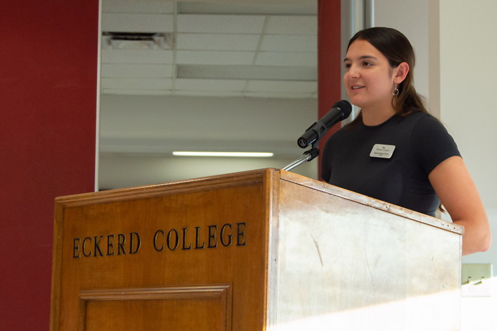 Student at podium that reads "Eckerd College"
