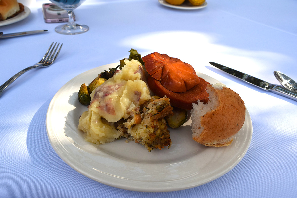 Plate of food sits on a table with sunlight hitting it