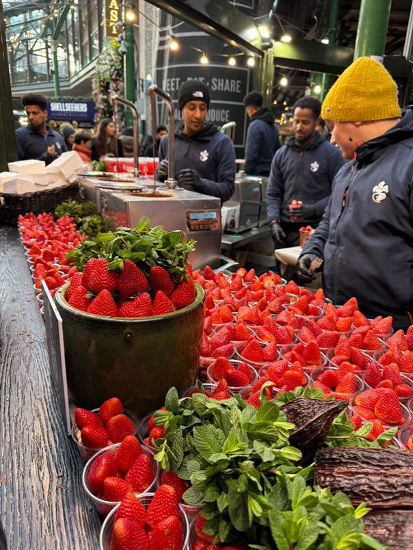 Vendors selling strawberries on a busy street