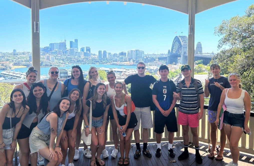 Group of students outside in front of city scape