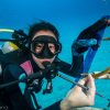 Scuba driver holding a piece of coral