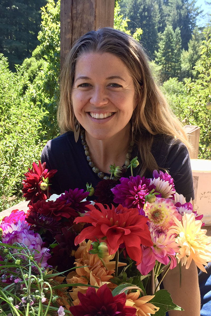 Woman standing in front of bouquet of wild lowers