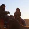 Student sits atop a camel