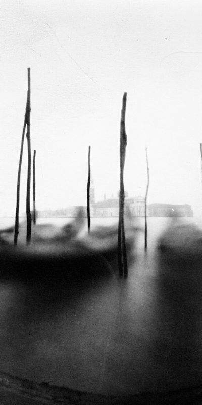 Black and white blurry photo of boats