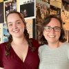 Student and professor stands side by side smiling