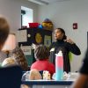 Eckerd student stands in a classroom before elementary school children