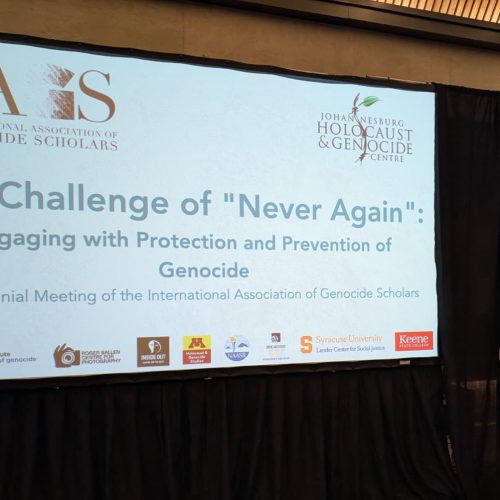 Hanna Kobs '26 stands next to a presentation display screen.