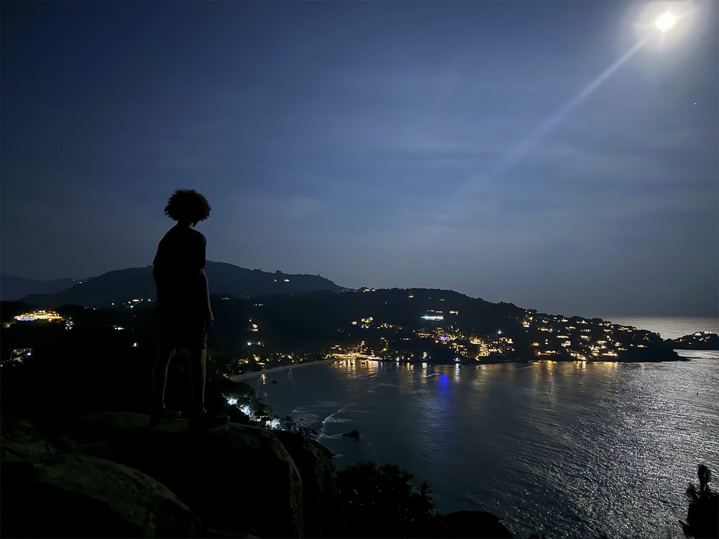 A night time shot of student admiring Shark Bay on Koh Tao