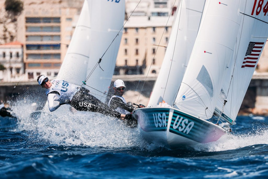 Woman in hat and sunglasses sailing in turbulent waters