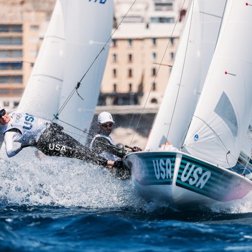 Woman in hat and sunglasses sailing in turbulent waters