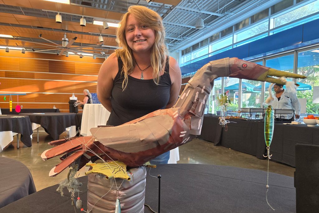 Olivia Kneebone and her sculpture titled intertwined