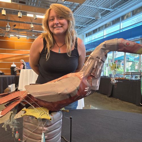 Olivia Kneebone and her sculpture titled intertwined