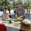 Two girls at a table with a two bowls of food on it.