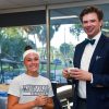 Gentleman in bow tie and jacket stands next to a student in a shirt that reads ECKERD TRITONS