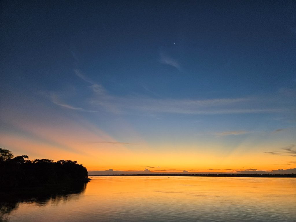A vibrant orange sky at dusk in Vale do Javari.