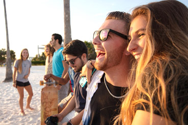 Students laughing on the beach