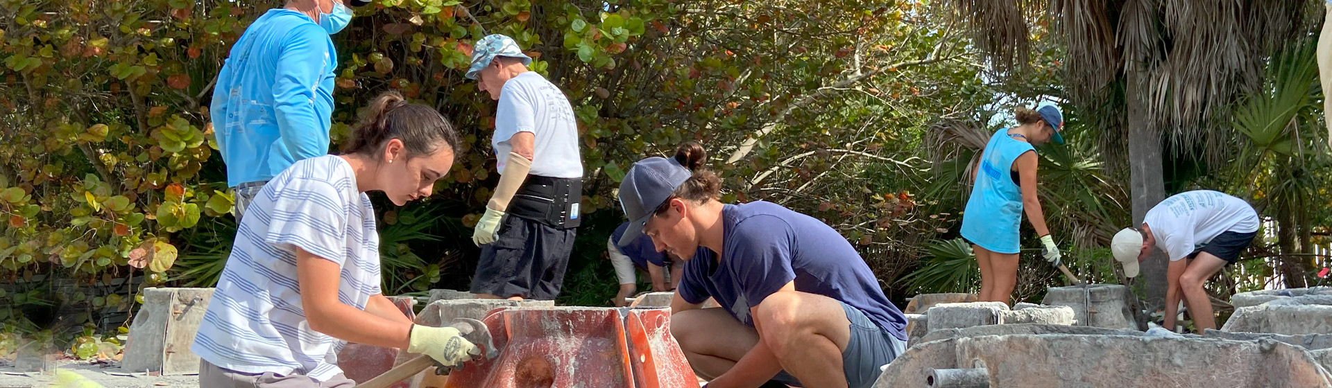 Students working together to make a concrete oyster ball
