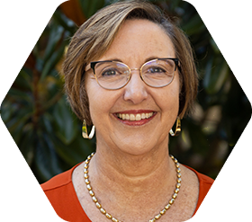 Woman in glasses smiling at camera