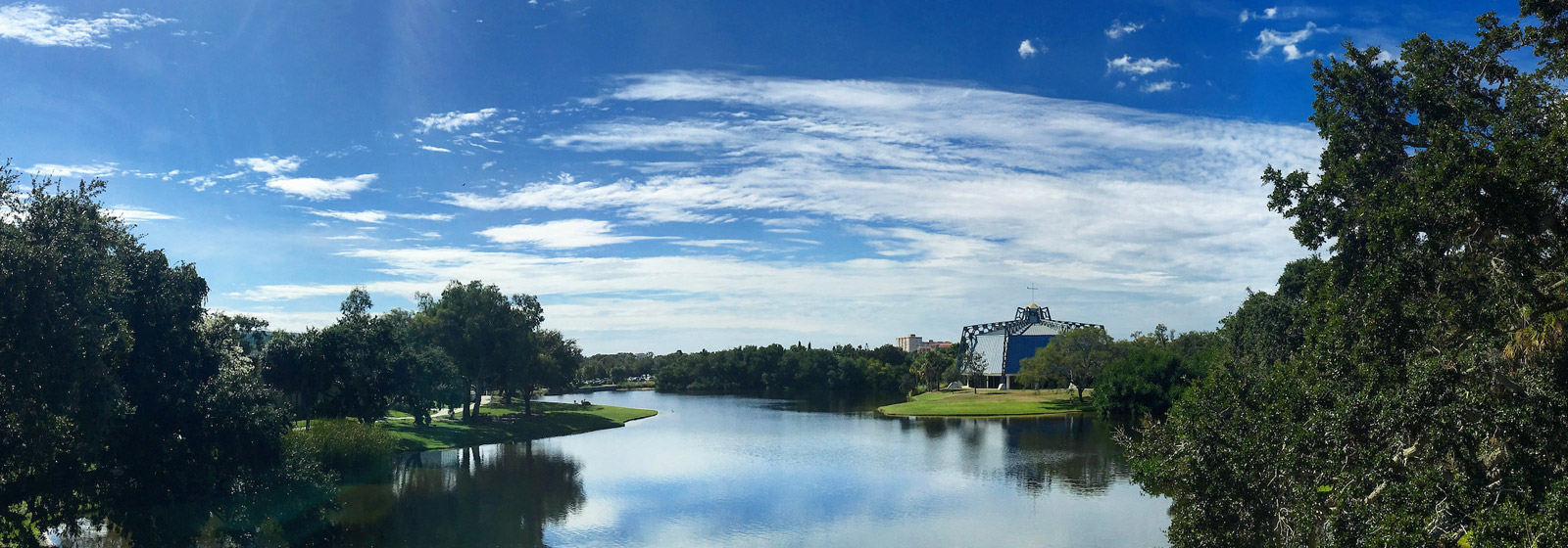 Long view of pond with chapel on its shores
