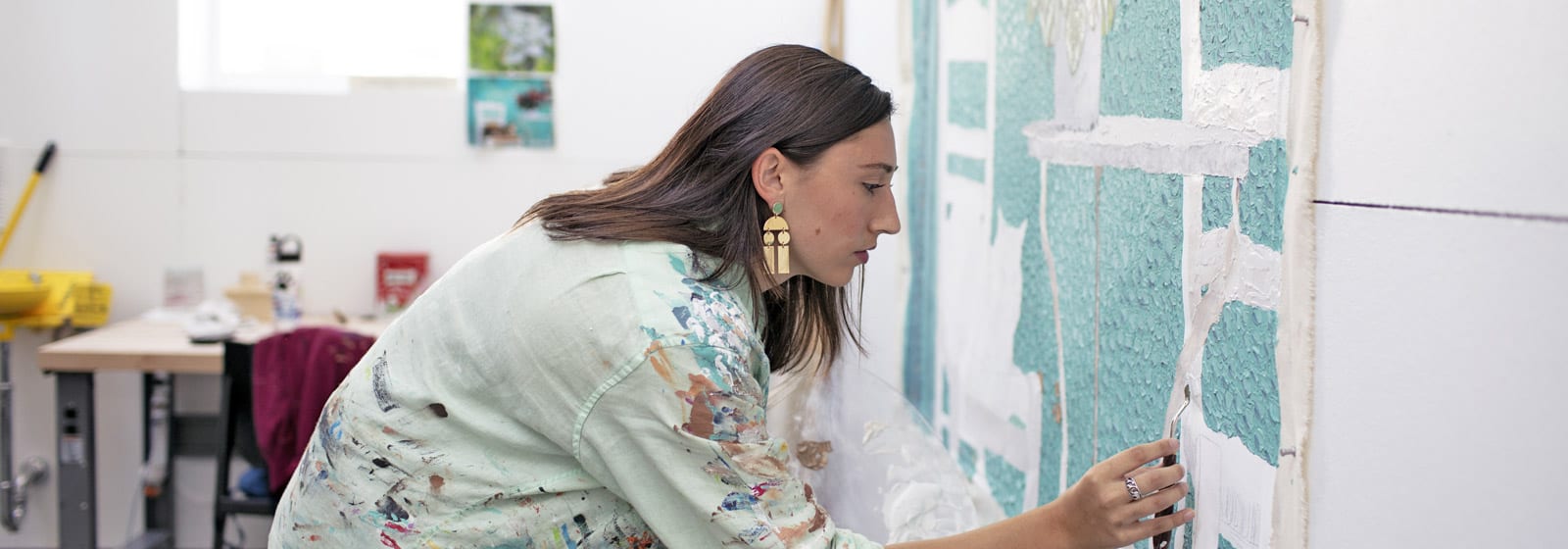 Student concentrating on painting