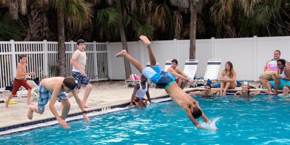 Summer Science Splash campers dive into the pool on Eckerd's campus