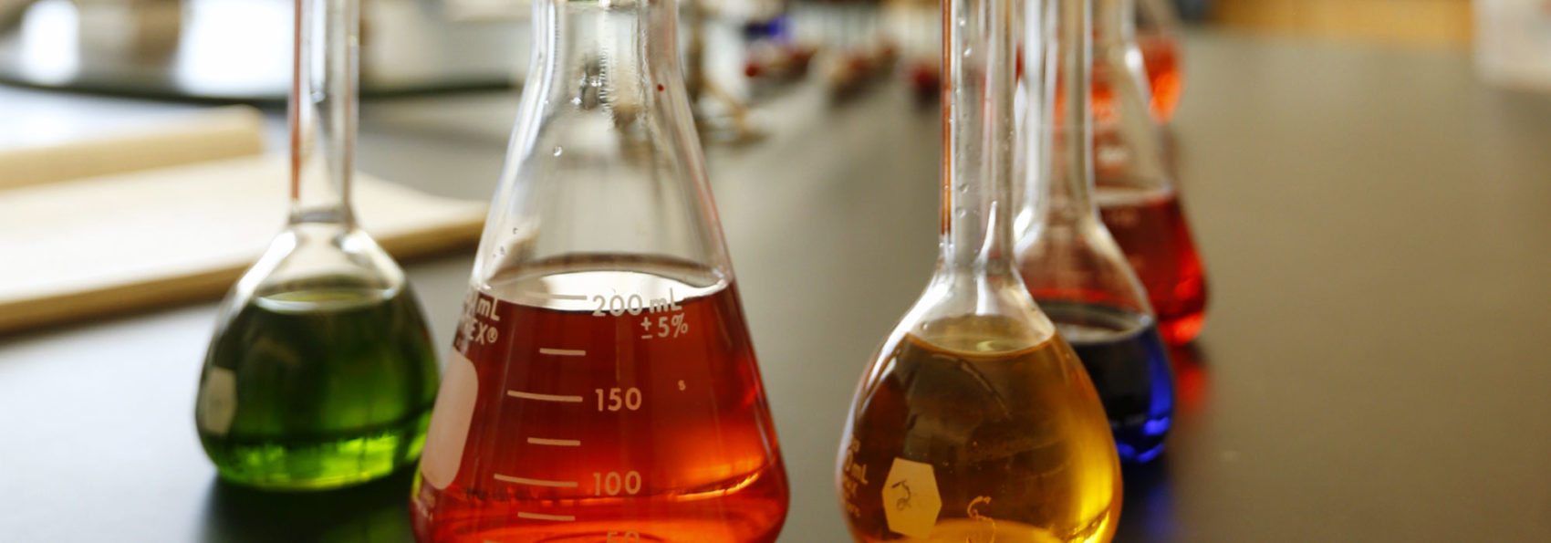 Beakers filled with colored liquid sitting on a lab table in James Center