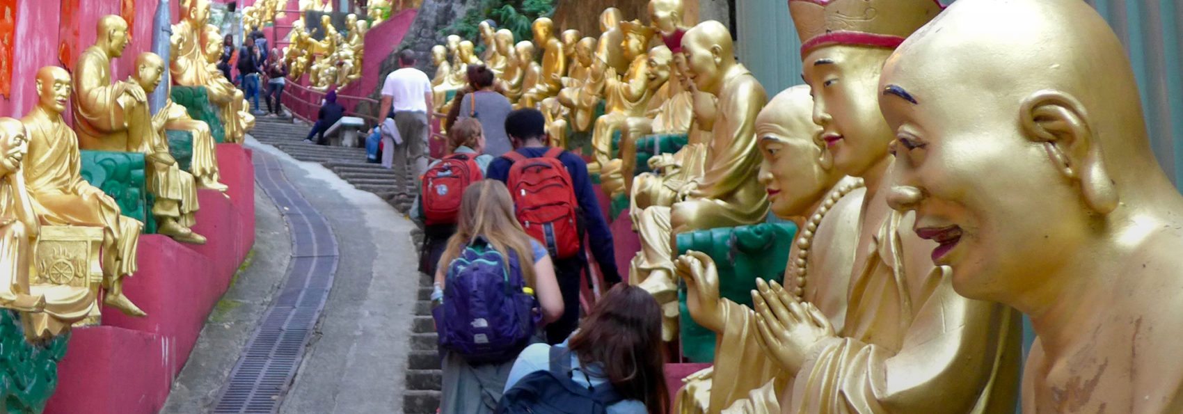 Photo of students walking up the stairs to the Temple of Ten Thousand Buddhas in Sha Tin, during 2016 Winter Term trip to Hong Kong, taken by Clifford Lezark '18.