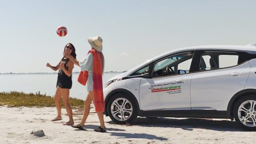 Students walking out of car onto beach