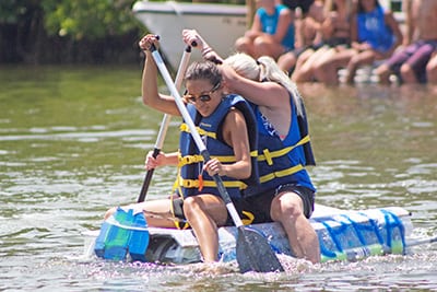 Students paddling the raft they made for the race