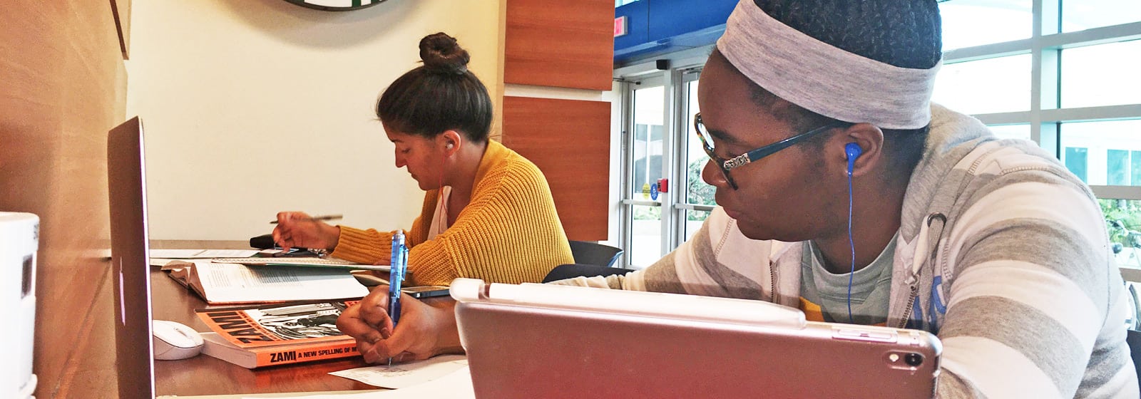 Students studying with laptop and books