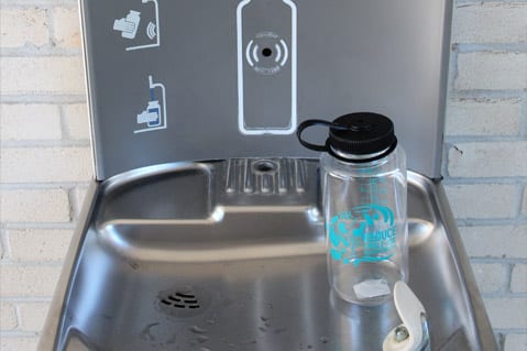 Water bottle filling station with reusable water bottle