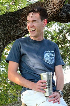 Student seated at the pub with reusable beverage container
