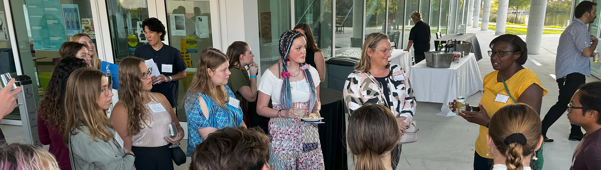 A large group of students listens to a potential employer