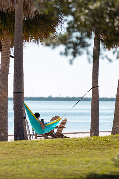 Student in hammock by the water