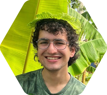 Student in glasses wearing cabbage leaf on his head like a hat