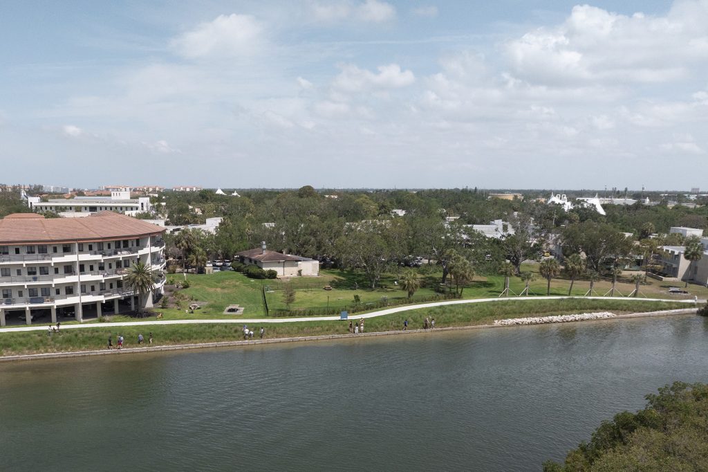 Aerial view of students walking along raised shoreline